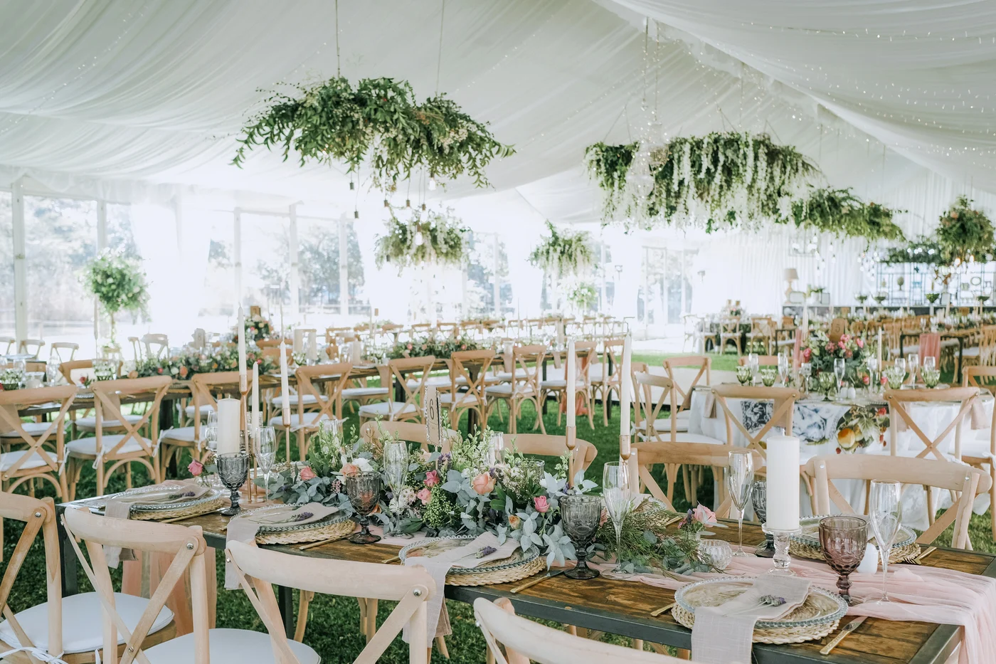Elegant marquee reception with flowers and table settings